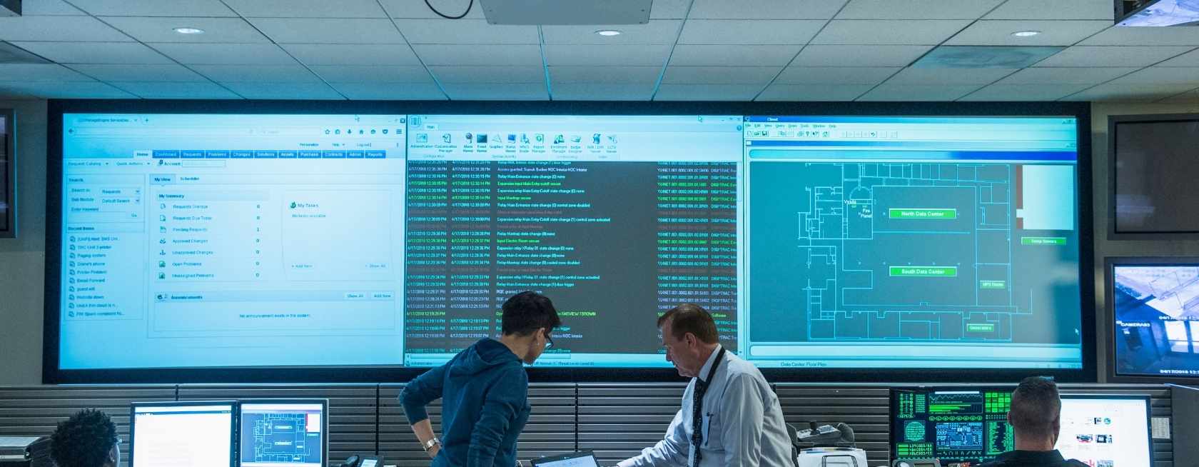 Colleagues working together in server control room