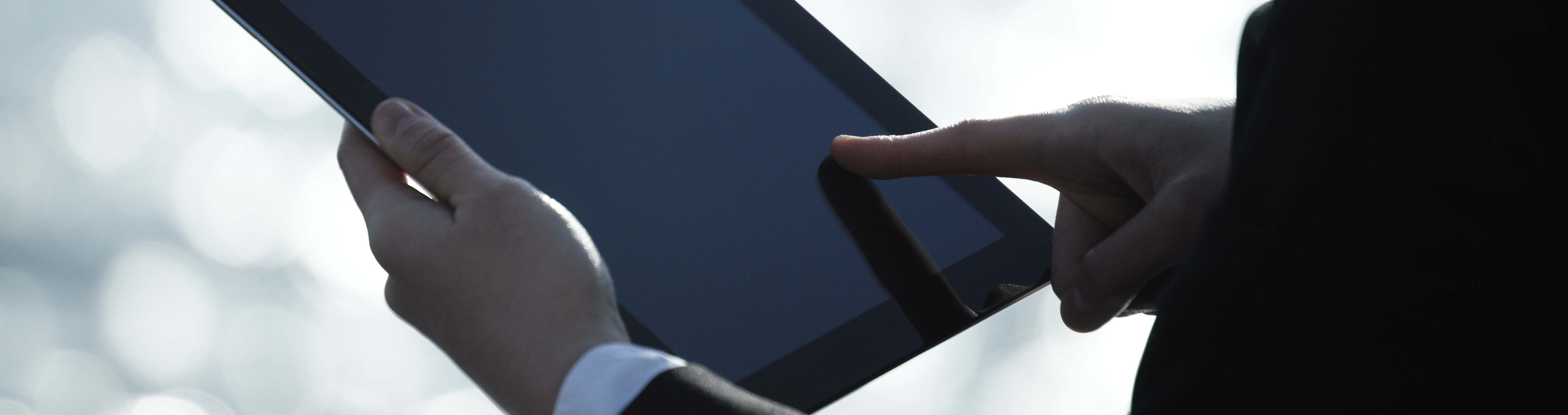 Person typing on a tablet